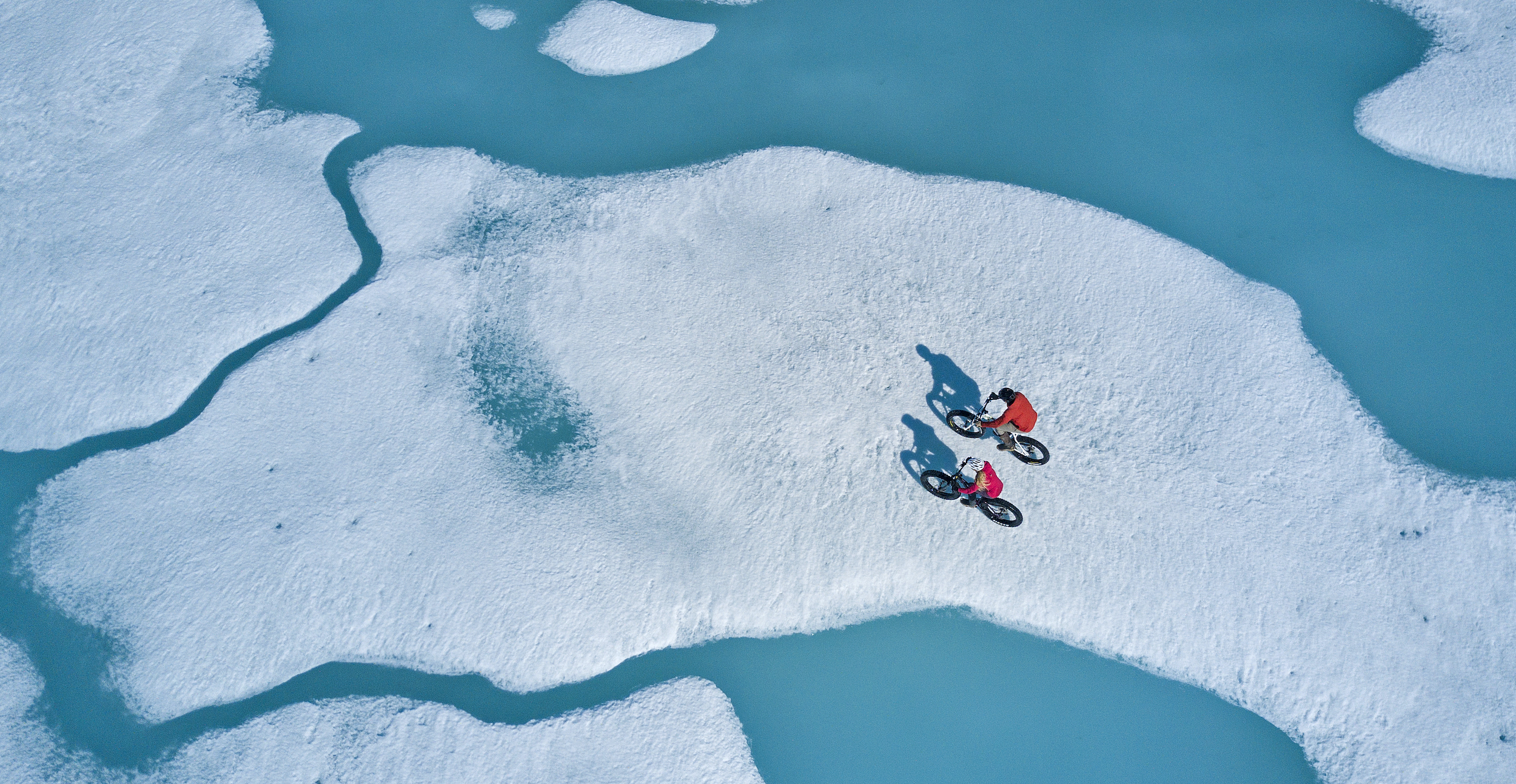 Biking on the Arctic Northwest Passage ice near Arctic Watch